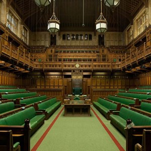 The green benches of the House of Commons Chamber with the Speaker's chair in the centre