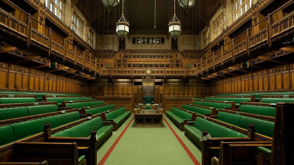 The green benches of the House of Commons Chamber with the Speaker's chair in the centre