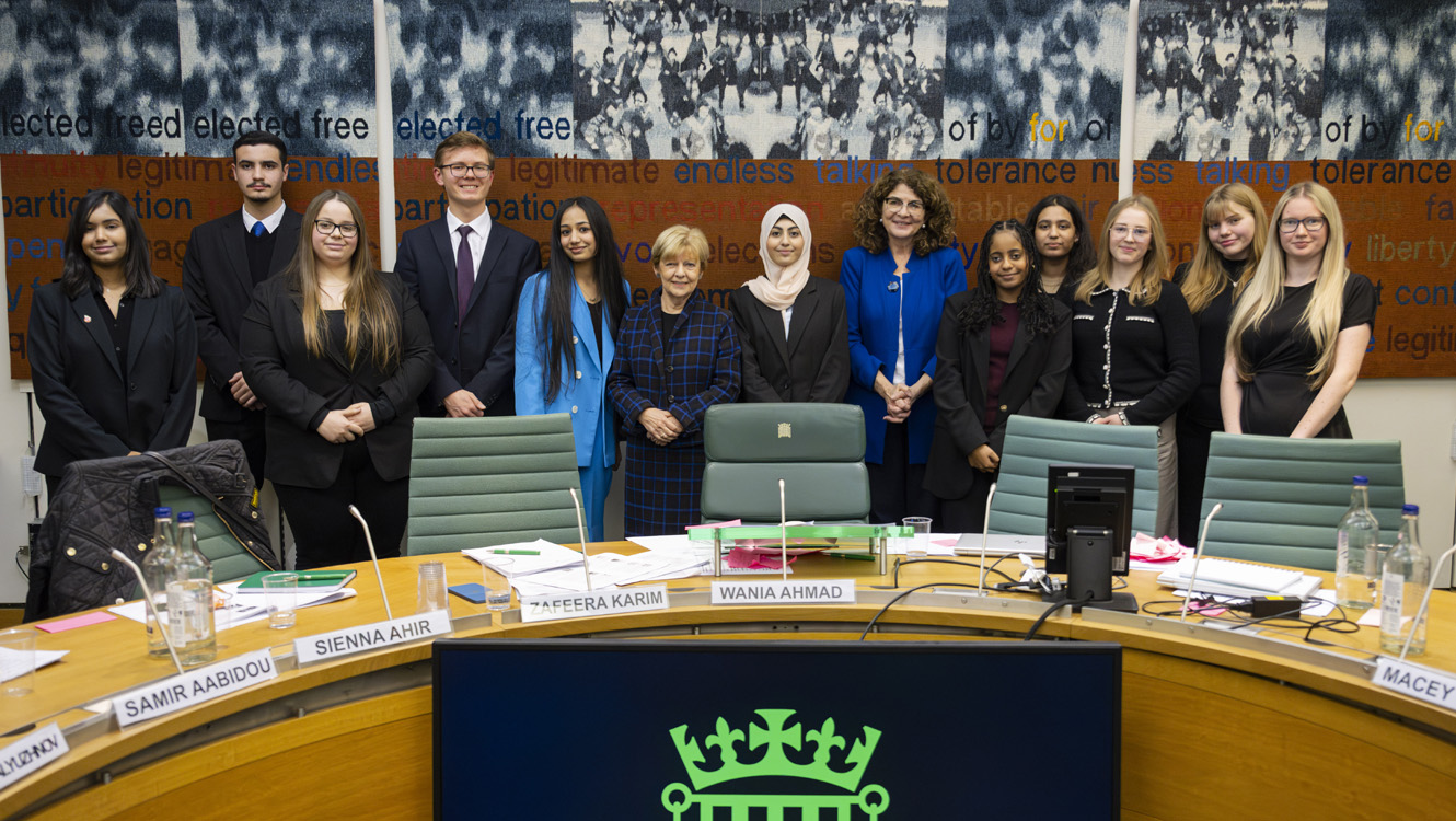 Members of the Youth Select Committee standing facing the camera,