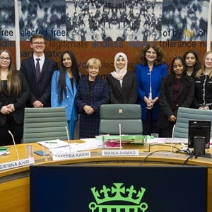 Members of the Youth Select Committee standing facing the camera,