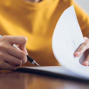 A woman signing a contract