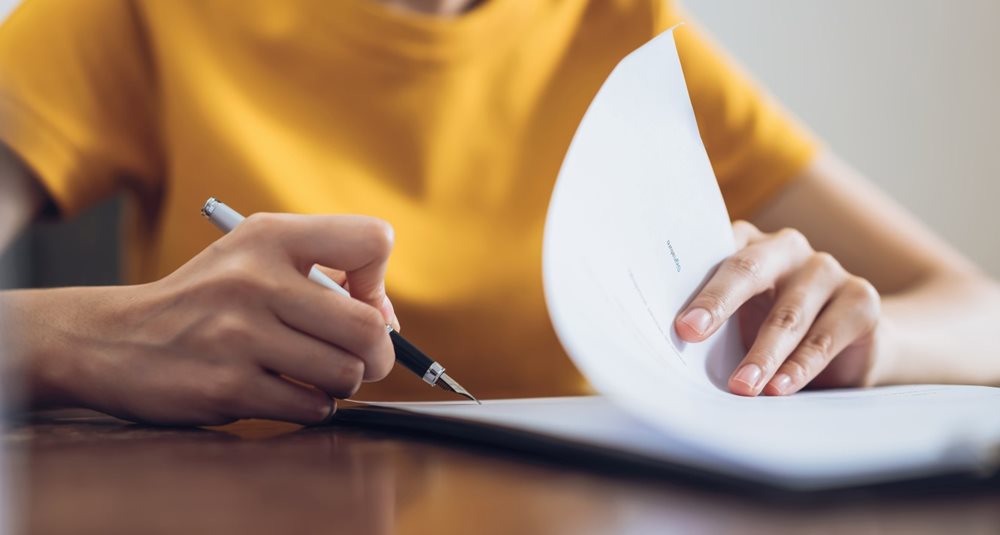 A woman signing a contract