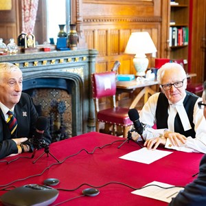 The Speaker of the House of Commons, Lord Speaker and podcast host Matthew Purvis sit around a table in front of microphones