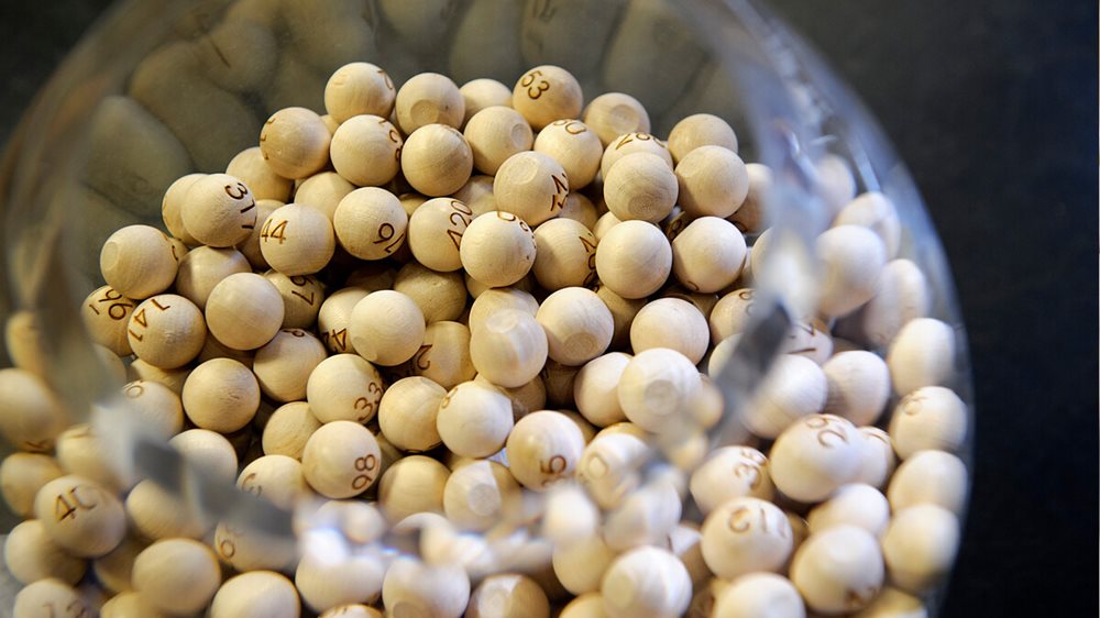 A glass bowl containing numbered wooden balls